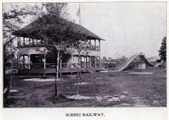 The Scenic Railway roller coaster carrying riders along the lake to the park's two-story dance pavilion, 1900