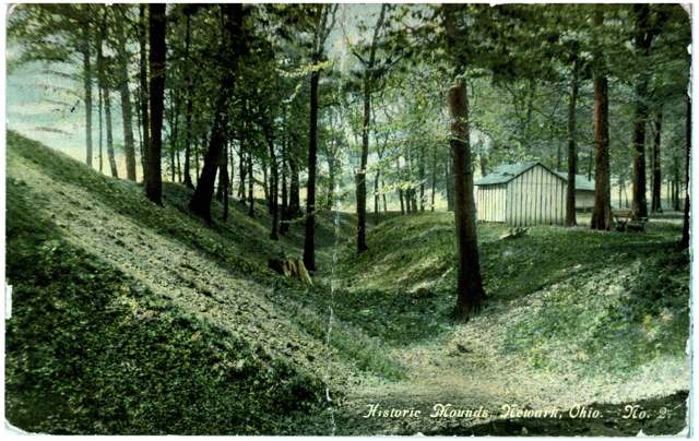 Postcard captioned 'Historic Mounds, Newark, Ohio,' showing tree-covered earthwork mounds of the Newark Earthworks