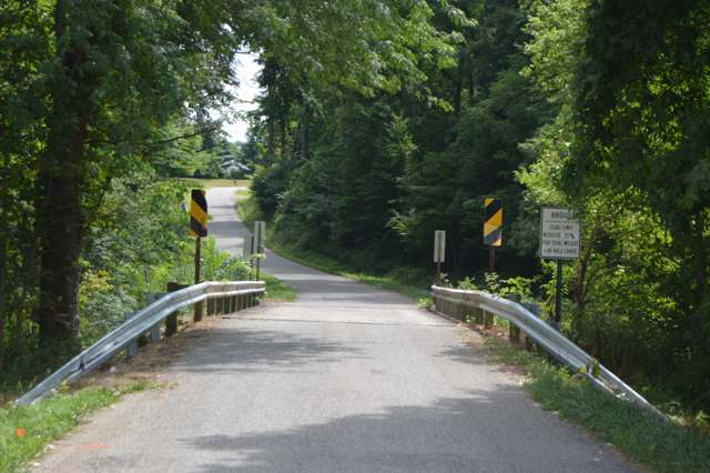 The Dutch Cross Road bridge over the Otter Fork today, reusing the old covered bridge's wooden deck and supports on a modern girder structure; photographed 2016