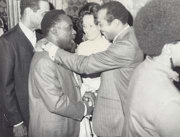 Bob Madison shakes hands with Cleveland elected mayor Carl Stokes.