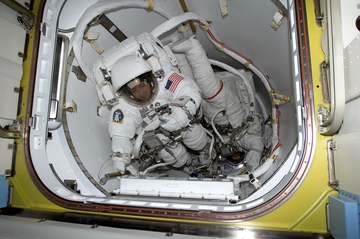 Astronauts Daniel W. Bursch (left) and Carl E. Walz are photographed in the crew lock of Quest prior to the February 20 
