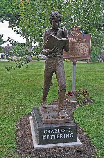 KETTERING STATUE AS A YOUTH BECAUSE AT AN EARLY AGE HE DEMONSTRATED HIS INVENTIVE GENIUS. KETTERING WAS A GRADUATE OF LO