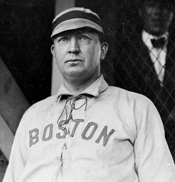 Baseball Player, Cy Young, Boston Americans, standing by grandstand concourse netting[1903]