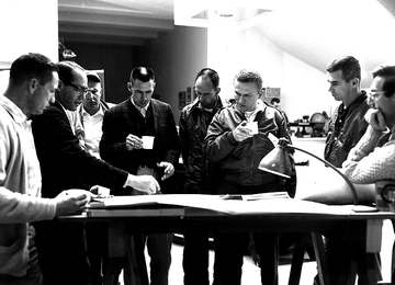 Don E. Wilhelms (second from left) briefing astronauts in 1964. Some of the astronauts include Donn F. Eisele (far left)