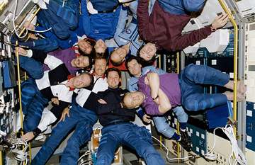 Inside the Spacelab Science Module, the crewmembers of STS-71, Mir- 18, and Mir-19 pose for the traditional inflight pic