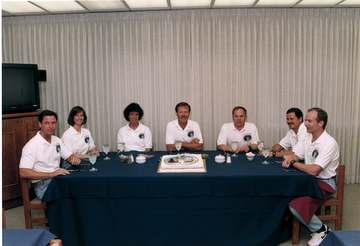 Their launch day already well under way, the STS-71 flight crew pauses for lunch and a photo session in the Operations a