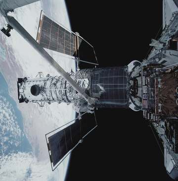 This wide shot of the Hubble Space Telescope (HST) in Discovery's cargo bay, backdropped over Australia, was taken durin