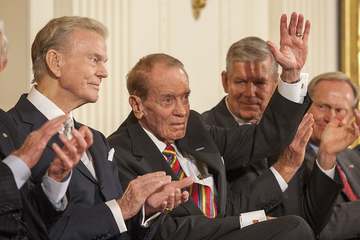 Former Mississippi Congressman and decorated war veteran, G.V. Sonny Montgomery, center, waves as he is introduced, and 