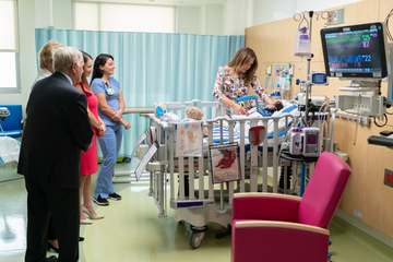 First Lady Melania Trump, joined by Jack and Barbara Nicklaus and hospital staff, visits with 8-month-old patient, Berna