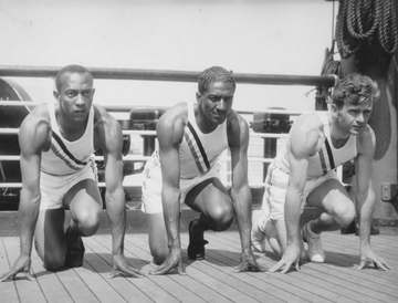 Photo of US Olympic team sprinters (from left) Jesse Owens, Ralph Metcalfe and Frank Wykoff on the deck of the S.S. Manh