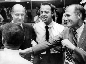 Astronauts Tom Stafford, Alan Shepard and John Glenn celebrate in Mission Control at the conclusion of the Apollo 11 mis
