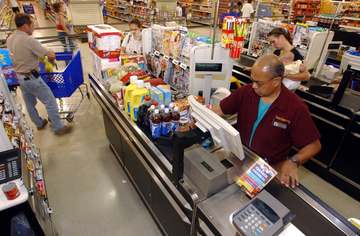 Virginia Beach, Va. (Aug. 13, 2002) -- A Navy family unloads their shopping cart while purchasing groceries at the Navy 