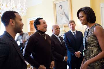 First Lady Michelle Obama greets, from left, John Legend, Smokey Robinson, Berry Gordy, and Bob Santelli in the Old Fami
