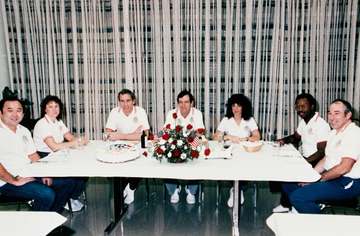 STS-51-L astronauts Onizuka, left, McAuliffe, Smith, Scobee, Resnik, McNair, and Jarvis enjoy the traditional prelaunch 