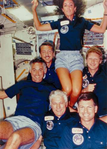Crewmembers of NASA's 41-D mission take a group shot displaying their fun moments in space aboard the orbiter Discovery.