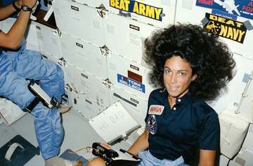 Astronaut Judith A. Resnik, one of three mission specialists, positions herself on the floor of the Space Shuttle Discov