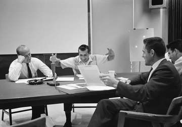 Discussing the S-13, Ultraviolet Astronomical Camera Experiment, during the postflight experiments briefing at the Manne