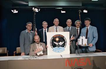 The seven crewmembers for STS 51-F/Spacelab 2 pose for photographers following their pre-flight press conference in the