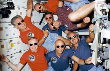 Crew portrait with sunglasses. C. Gordon Fullerton's head is at center. Others (bottom,l.-r.) are Roy D. Bridges, F. Sto