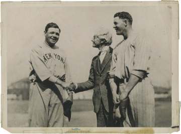 Commissioner Kenesaw Mountain Landis shakes hands with Babe Ruth while keeping hold of Bob Meusel after refusing to lift