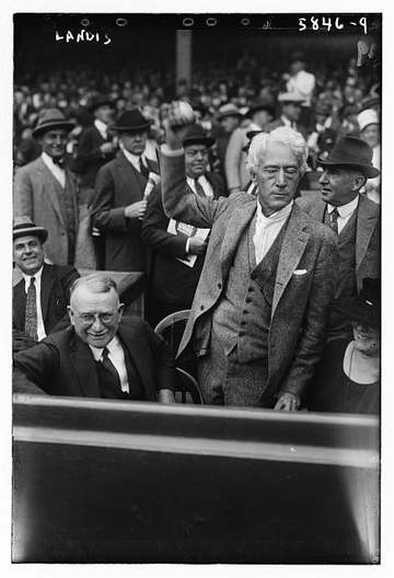 An unsmiling Commissioner of Baseball Kenesaw Mountain Landis throws out the first pitch.