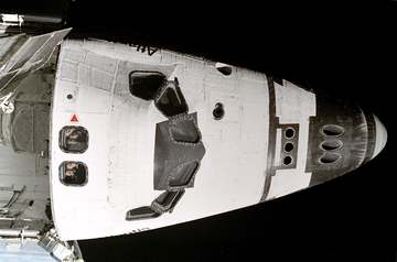 The five STS-74 astronauts aboard the space shuttle Atlantis look out overhead windows on the aft flight deck toward the
