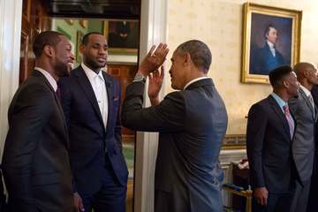 President Barack Obama talks with 2013 NBA Champion Miami Heat players Dwyane Wade, left, and LeBron James in the Blue R