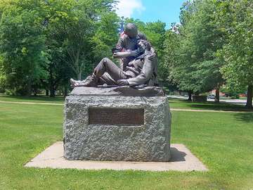 Photo of a memorial statue depicting Mary Ann "Mother" Bickerdyke taking care of a wounded soldier. Memorial located at 