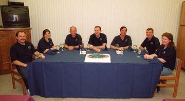 In the Operations and Checkout Building, the STS-101 crew gathers for a snack before suiting up for launch. From left ar