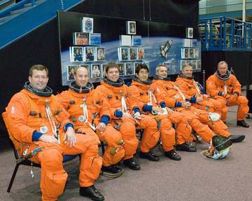 Attired in training versions of their shuttle launch and entry suits, the STS-123 crew members await the start of a trai
