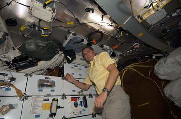 STS-125 Mission Specialist 1 (MS1) Michael Good poses for a photo in the shuttle Atlantis middeck.