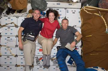 STS-125 Mission Specialist 2 (MS2) Megan McArthur (center), MS5 Andrew Feustel (right), and MS1 Michael Good pose for a 