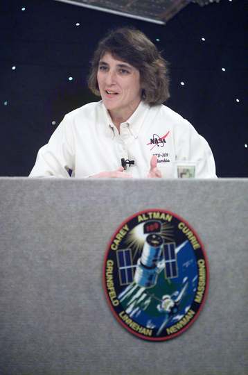 Astronaut Nancy J. Currie, STS-109 mission specialist, fields a question during a pre-flight press conference at Johnson
