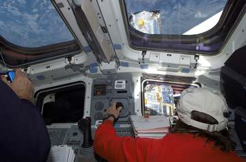 Astronaut Nancy J. Currie, mission specialist, controls the Remote Manipulator System (RMS) robotic arm of the Space Shu
