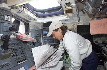 Astronaut Nancy J. Currie, mission specialist, remains near the controls (upper left) for Columbia's Remote Manipulator