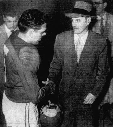 Head coach Paul Brown (right) shakes the hand of his quarterback, Otto Graham (left), following the American Conference