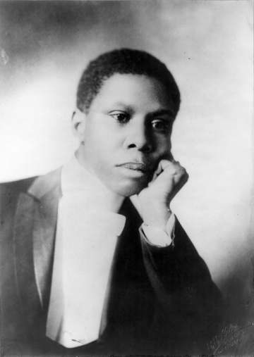 Paul Laurence Dunbar, bust portrait, facing right, head resting on left hand