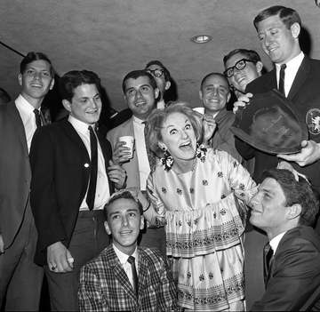 Comedienne Phyllis Diller is the center of attention as she becomes honorary house mother of Alpha Epsilon Pi Fraternity