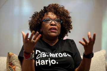Rita Dove speaking with attendees at an event titled "Legacies: A Conversation with Sandra Cisneros, Rita Dove and Joy H