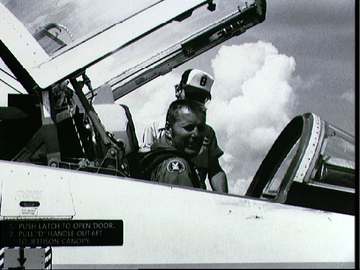 NASA Astronaut Robert F. Overmyer performing preflight checks of a T-38A aircraft at Ellington Air Force Base in Texas.