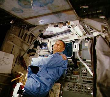 NASA Astronaut and STS-5 Pilot Robert F. Overmyer behind the pilot's seat on the flight deck of the Space Shuttle Columb