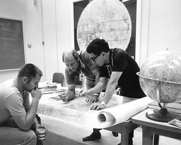 Farouk El-Baz reviewing lunar maps with Ronald Evans and Robert Overmyer.