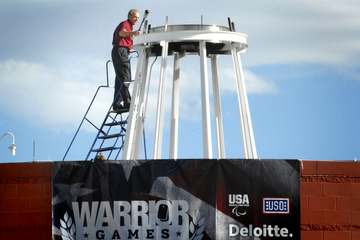 Legendary former Dallas Cowboys quarterback Roger Staubach lights the ceremonial torch at the inaugural Warrior Games at