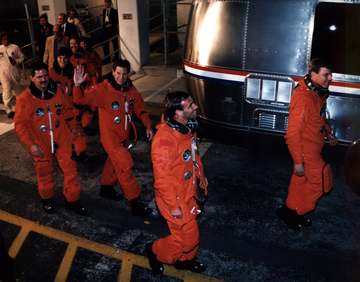 The STS-67 flight crew departs the Operations and Checkout Building, headed for Launch Pad 39A. Leading the way are Miss