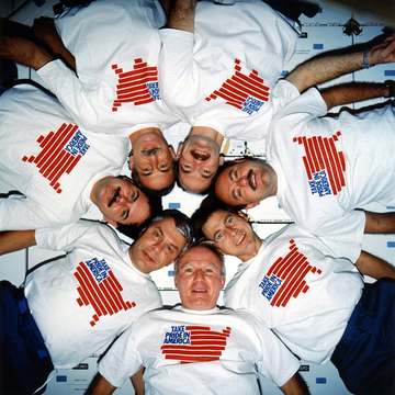 The crew of space shuttle mission STS-35 poses for the traditional inflight portrait.