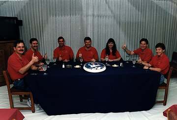 In the Operations and Checkout Building, members of the STS-67 flight crew have gathered for a meal prior to suiting up 