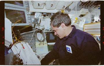 The original finding aid described this as: Description: STS-67 Payload Specialist Ronald Parise takes notes on the curr