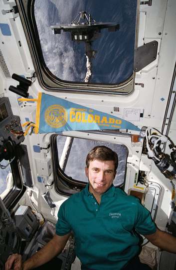 Astronaut Ronald M. Sega suspends himself in the weightlessness aboard the Space Shuttle Discovery's crew cabin during S