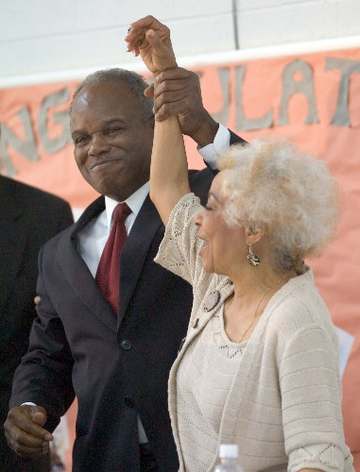 Congressman David Scott raises his arm with actress Ruby Dee following Dee's opening remarks