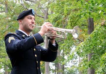 U.S. Army Staff Sgt. Jeff Hotz, a bugler with the 338th Army Band, U.S. Army Reserve performs taps in remembrance of for